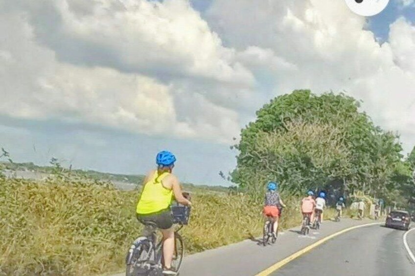 A road with cyclists and a car. 2