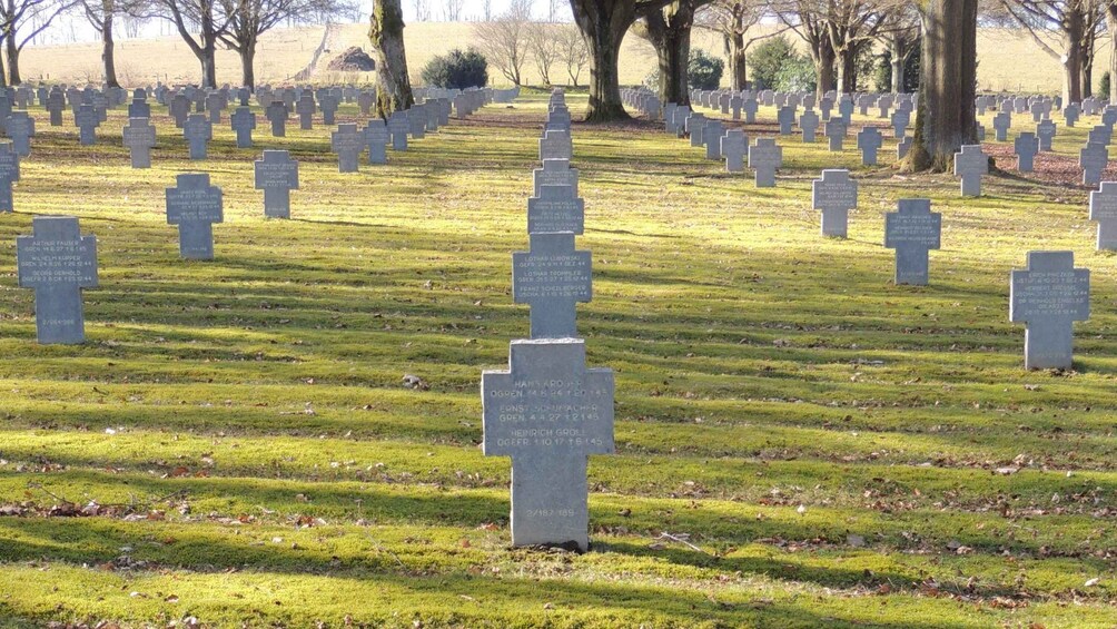 A cemetery with rows of headstones. 2
