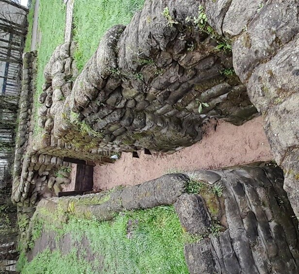 Ancient stone ruins with moss-covered walls and a small doorway. 3