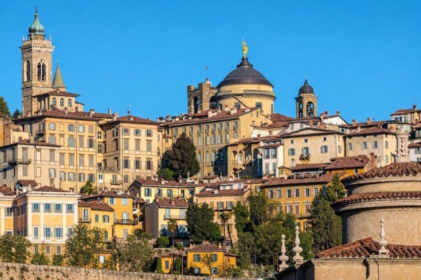 A historic cityscape with a prominent church, a bell tower, and a dome. 3