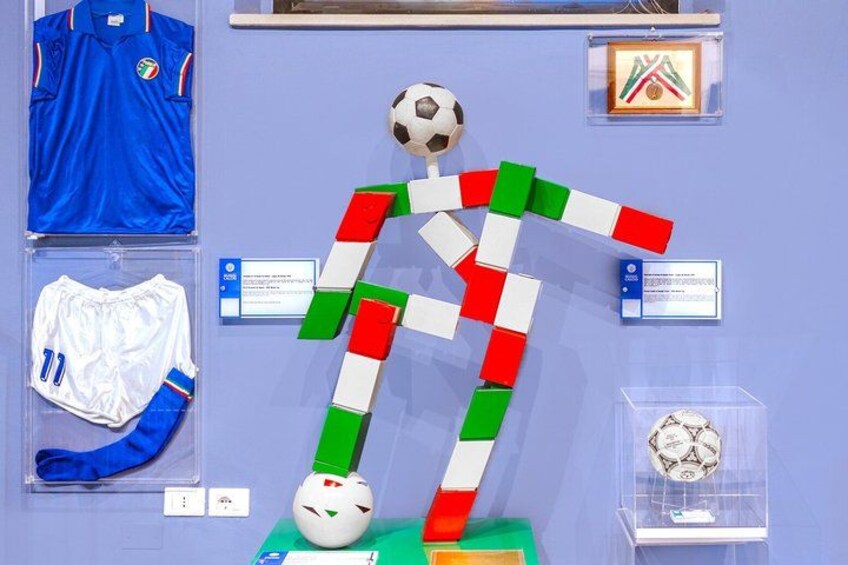 A soccer jersey, a soccer ball, and a trophy on display. 3