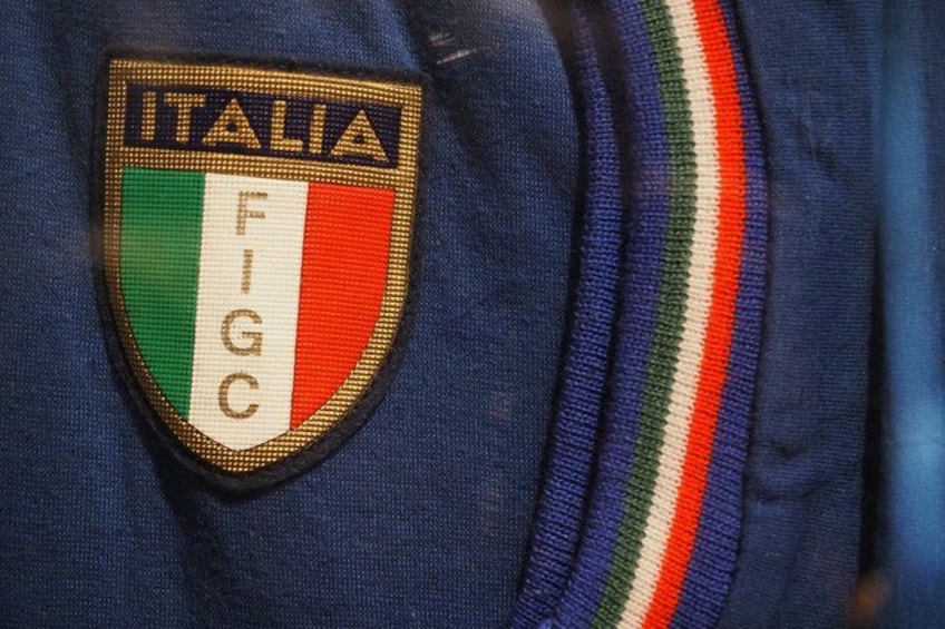 A close-up of a sports jersey with a patch that reads 'ITALIA FIGC'. 2