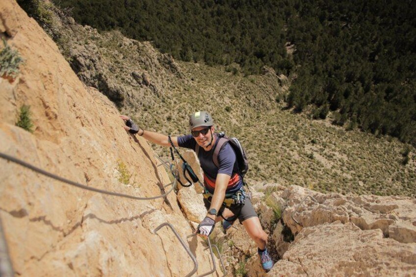 A person rock climbing on a rocky mountain. 5