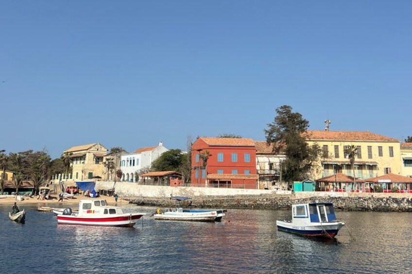 A waterfront with boats, buildings, and a clear sky. 5