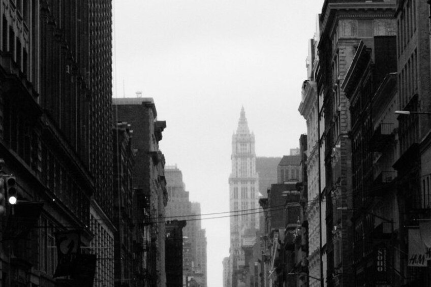 A city street with tall buildings and a distant tower. 5