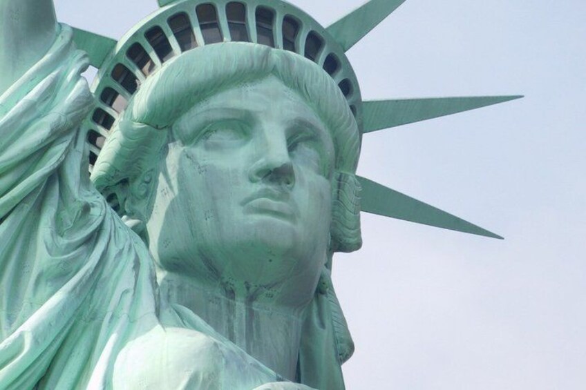 A close-up of the Statue of Liberty's head and right arm. 1