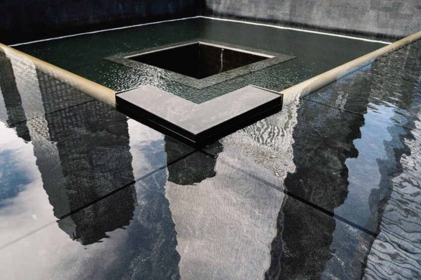 A reflective pool with a square-shaped drain in the center. 4