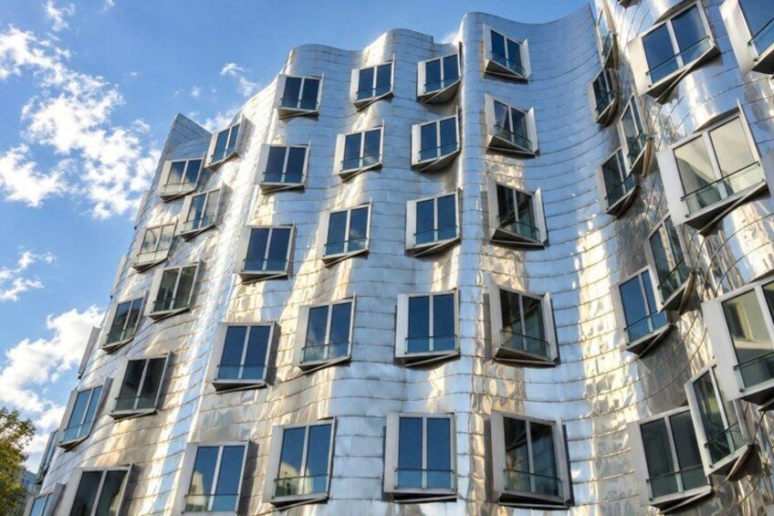 A modern building with a reflective facade and multiple windows. 4