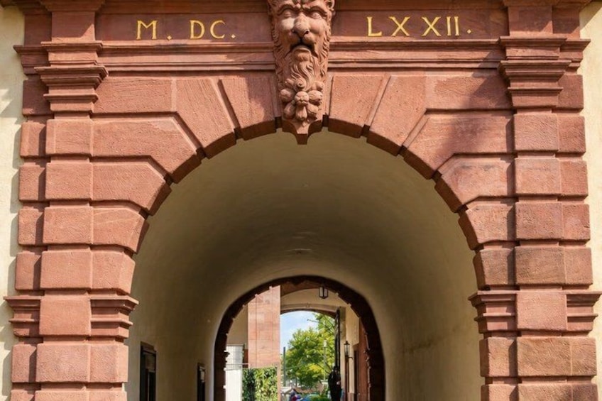 An arched stone gateway with inscriptions 'M. DC.' and 'LXXII.' 3