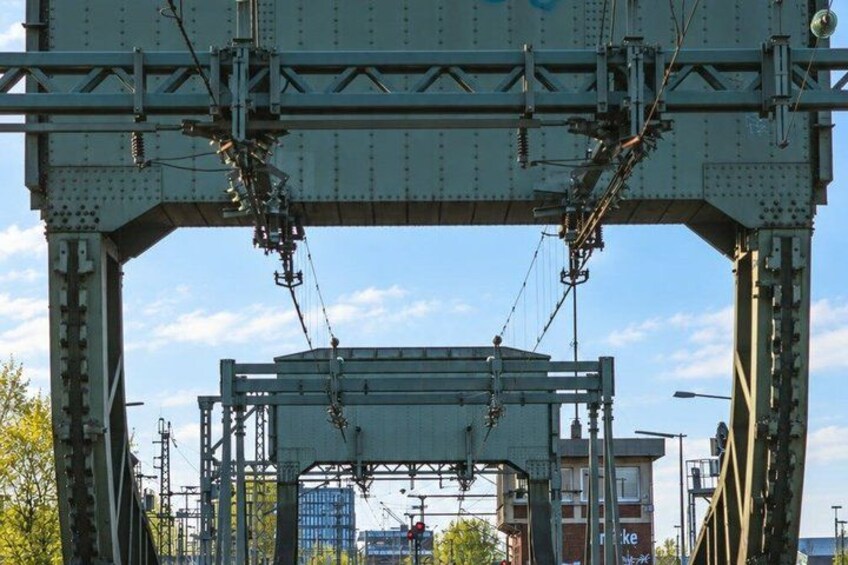 A large metal bridge structure with multiple levels and cables. 2