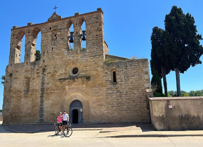 An old stone church with arched windows and a bell tower. 1