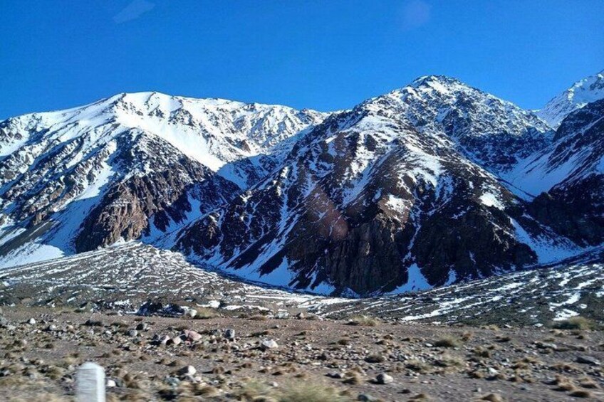A mountain range with snow-covered peaks and rocky terrain. 4
