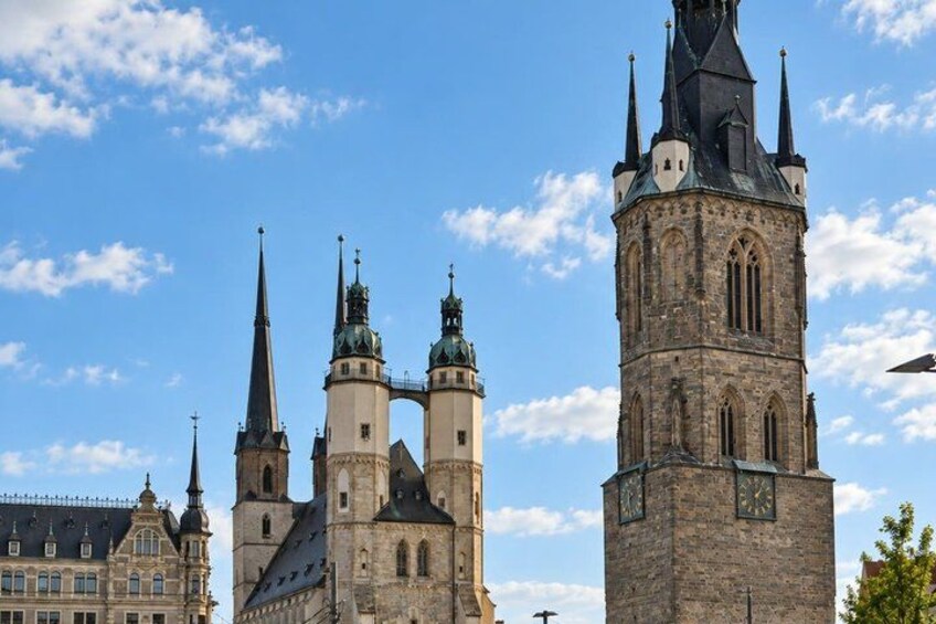 A historic church with multiple spires and a prominent clock tower. 4