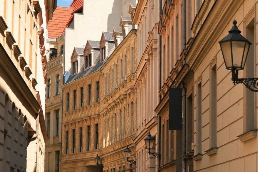 A street lined with historic buildings featuring ornate facades and traditional street lamps. 5