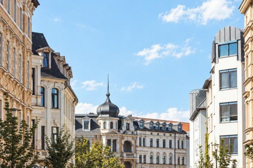 A historic building with a dome, surrounded by modern architecture. 3