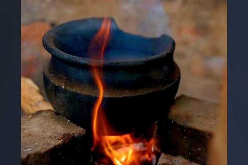 A black pot on a fire with flames. 2
