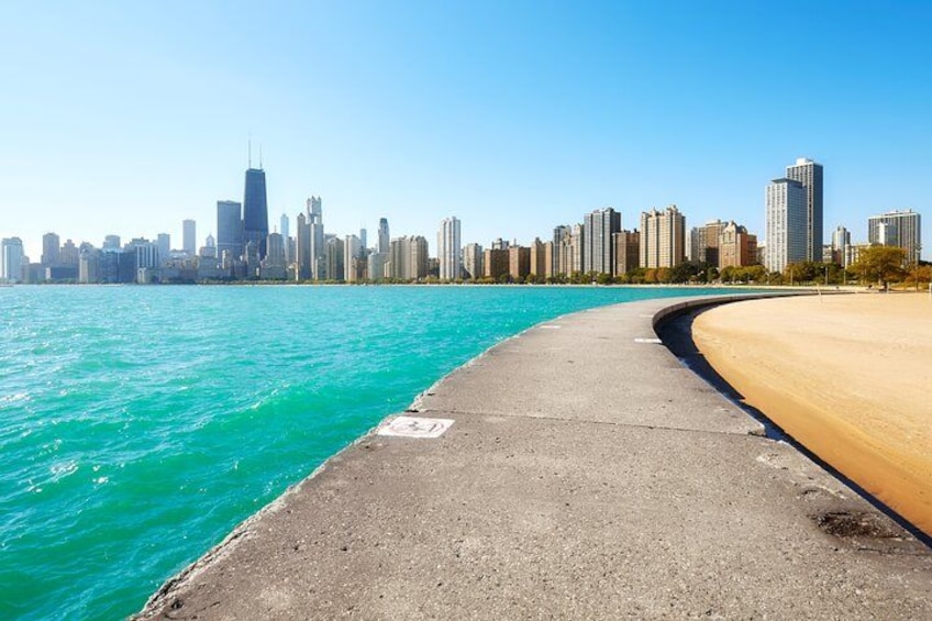 A waterfront promenade with a city skyline in the background. 5