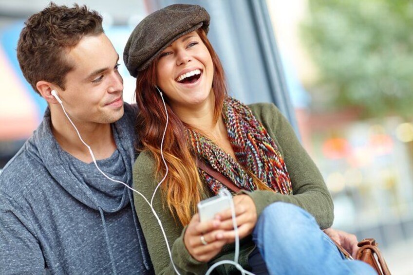 Two people sitting on a bench, one holding a smartphone. 3