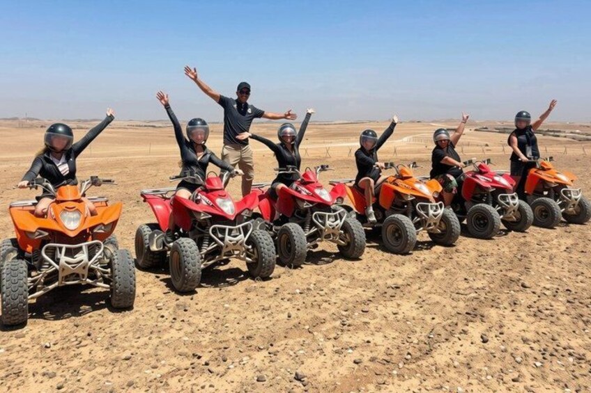 A group of people on ATVs in a desert landscape. 2