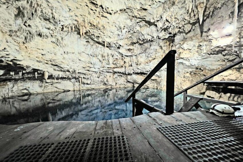 A cave with a wooden platform and metal grates. 2