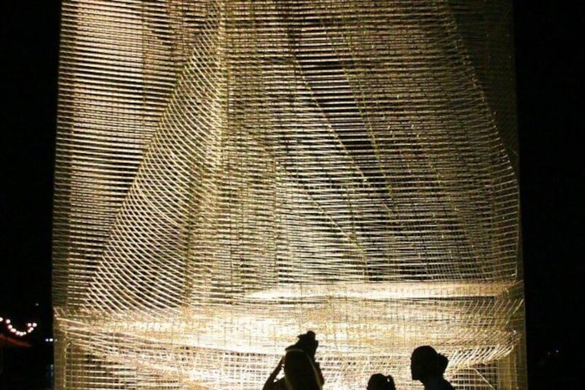 A large, textured installation with a grid-like pattern, possibly a sculpture or art piece. 4