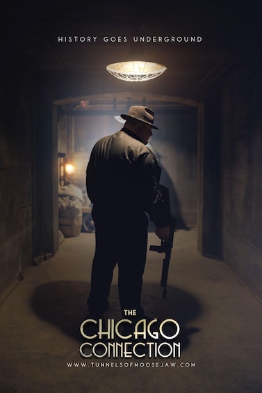 A man in a hat and jacket walking down a dimly lit corridor with a gun, heading towards a light source at the end. 5