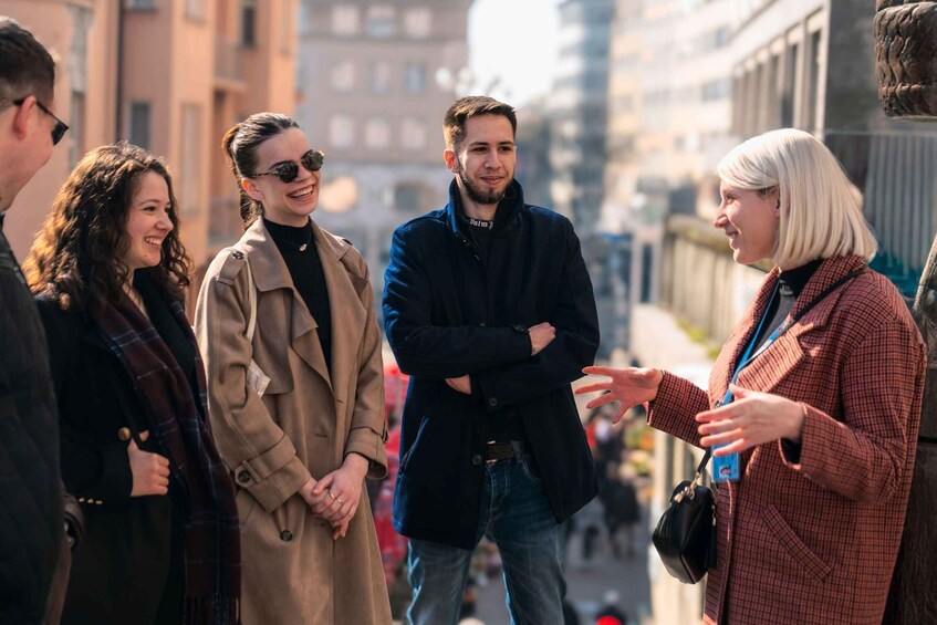 A group of people standing on a city street. 1