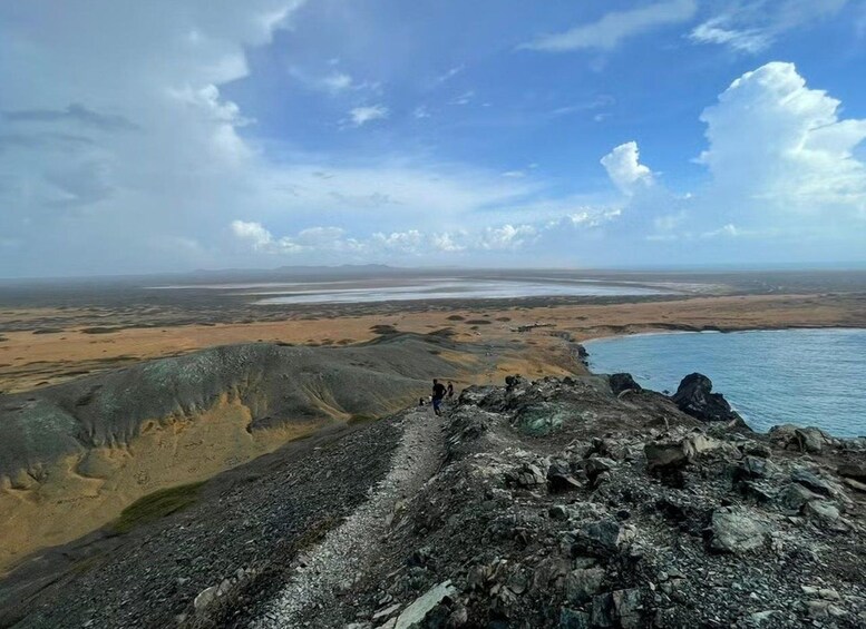A coastal landscape with rocky terrain and a distant shoreline. 2