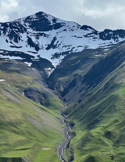 A mountain range with a river flowing through a valley. 4
