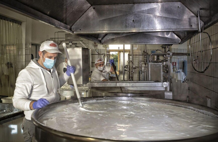 A large industrial kitchen with stainless steel surfaces and equipment. 3