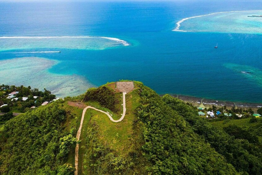 A coastal landscape with a clear path leading to a small island surrounded by turquoise waters. 1