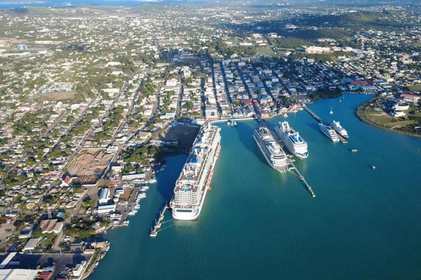 A large cruise ship docked at a port with several smaller boats nearby. 4