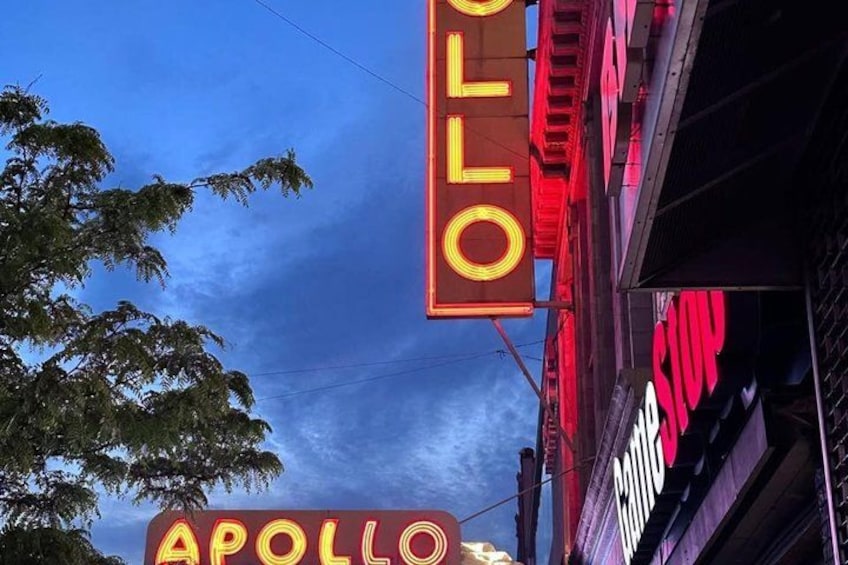 Neon signs with the words 'APOLLO' and 'OFF' against a twilight sky. 2