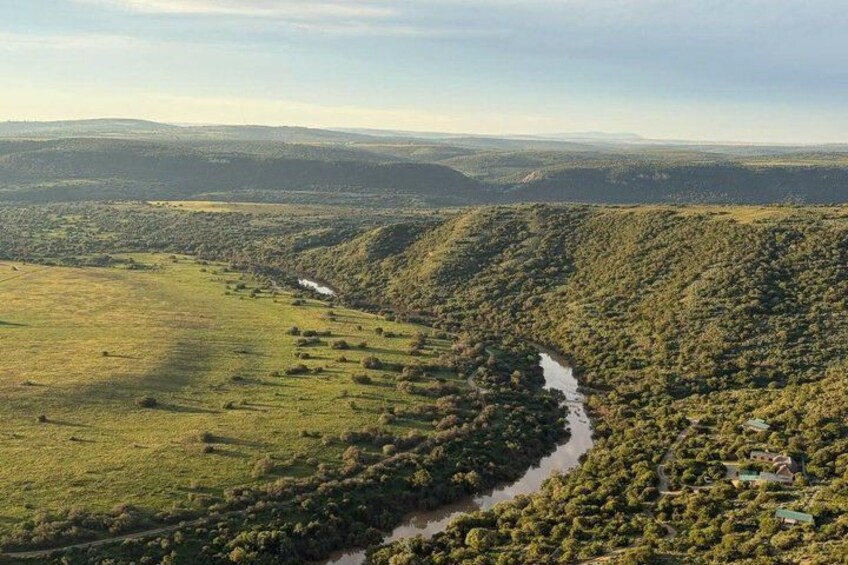 A river winding through a valley with hills on either side. 2