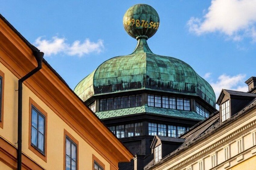 A building with a green dome and a spherical structure on top. 3