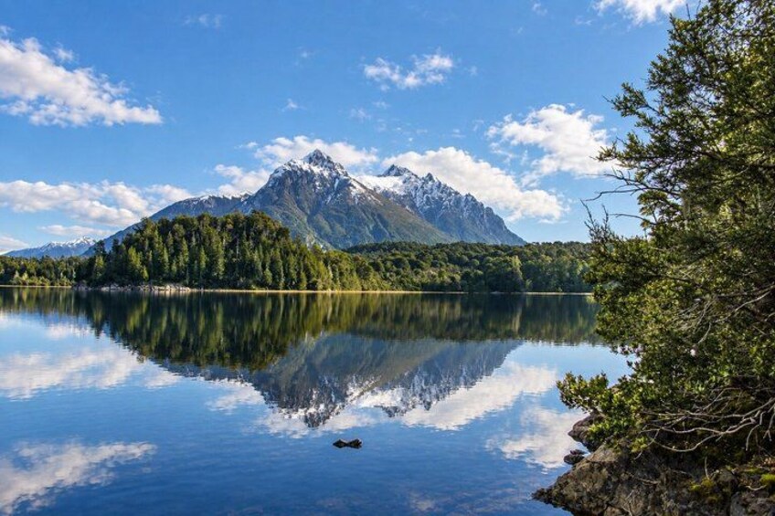 A mountain lake with a reflection of the mountain and trees. 3