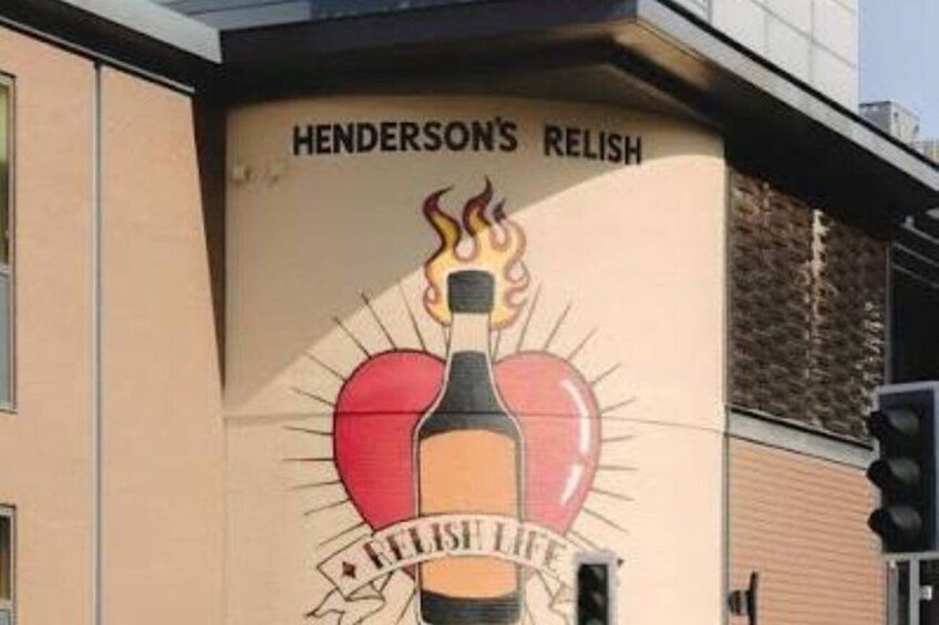 A building with a mural of a bottle with flames and a heart, and the words 'HENDERSON'S RELISH' and 'RELISH LIFE' on the wall. 1