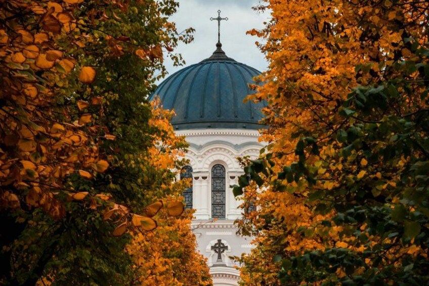 A church with a dome, surrounded by autumn foliage. 5