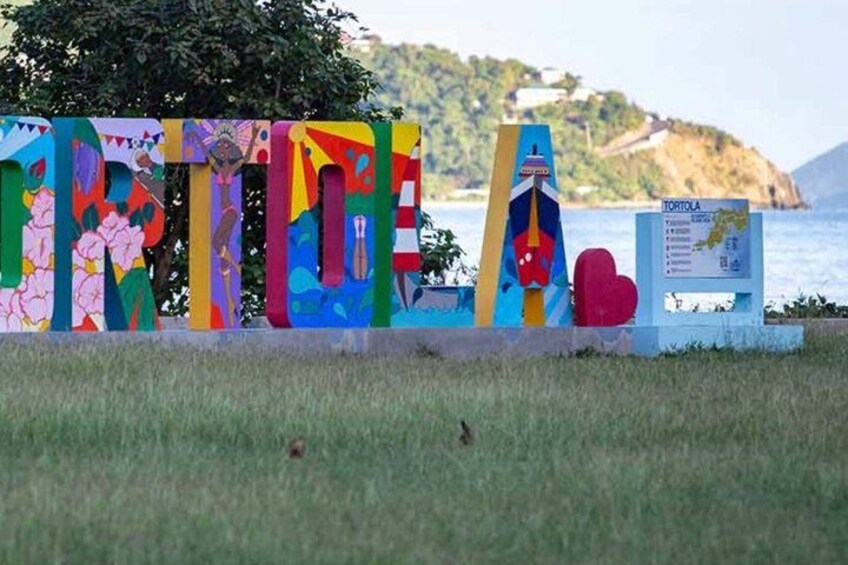 A colorful sign with the word 'TORTOLA' and a map. 4