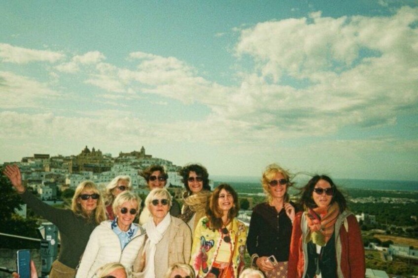A group of people on a rooftop with a cityscape in the background. 3