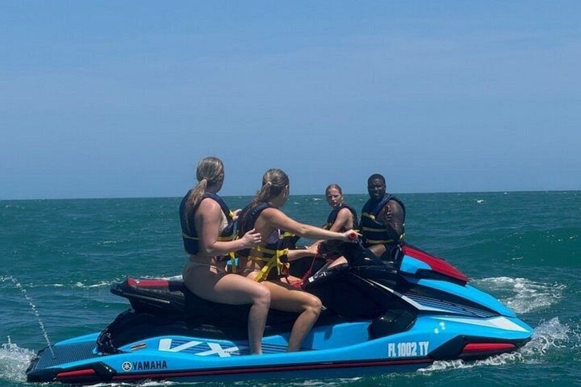 A group of people on a jet ski in the ocean. 2