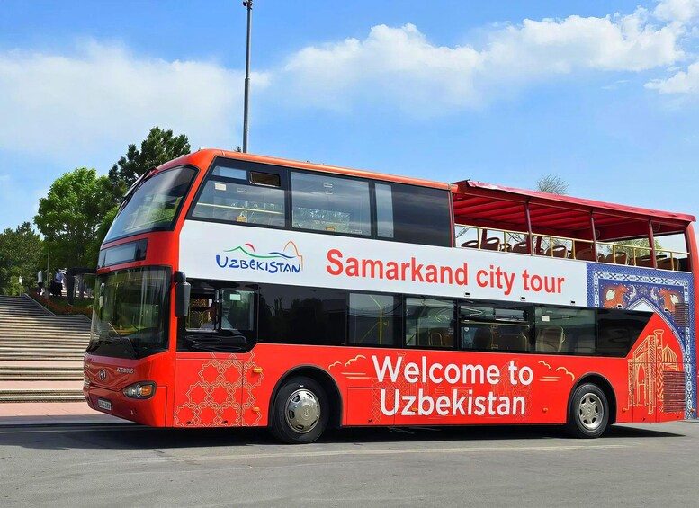 A red double-decker bus with 'Welcome to Uzbekistan' and 'Samarkand city tour' on the side. 1