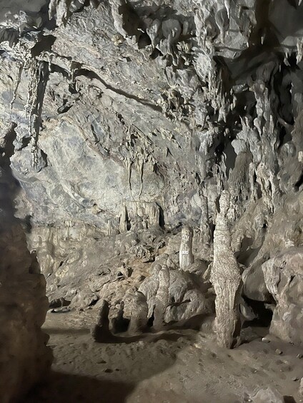 A cave interior with stalactites and stalagmites. 4