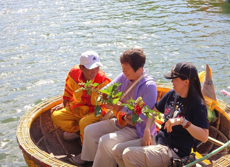 Three people in a boat on a body of water. 4