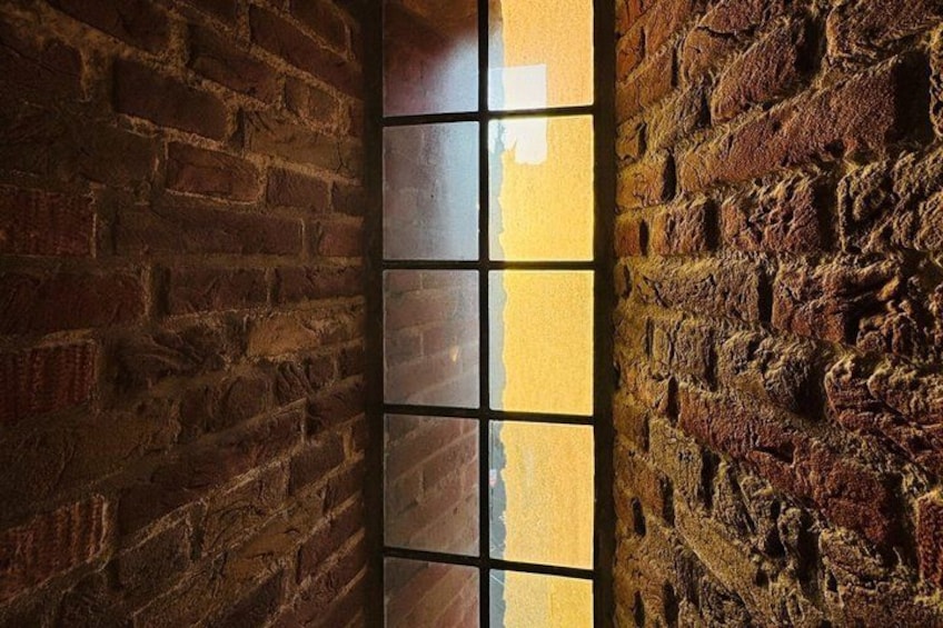 A brick wall with a window. 3