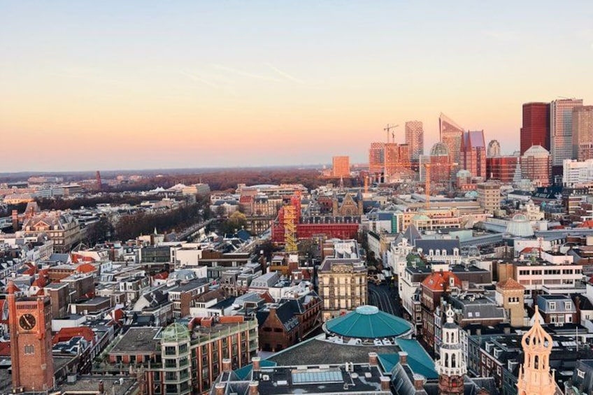 A cityscape with historic buildings, modern skyscrapers, and a prominent church spire. 4