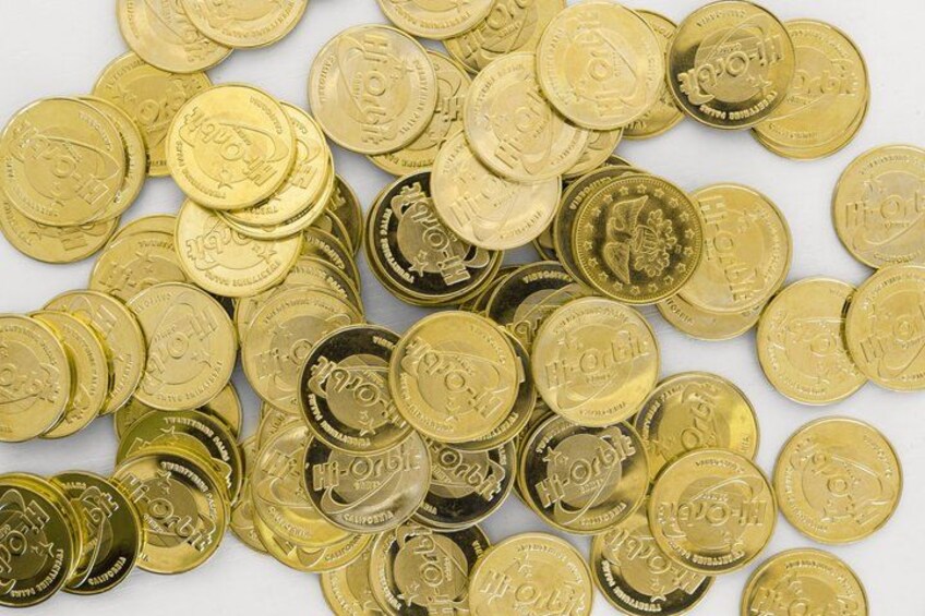 A collection of gold-colored coins with inscriptions. 2