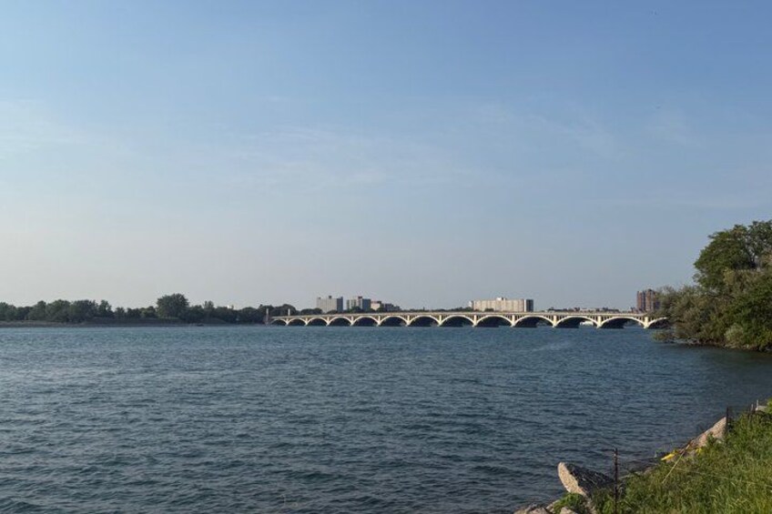 A bridge over a river with a city skyline in the background. 2