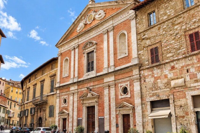 A historic building with a classical facade, arched windows, and a central entrance. 4