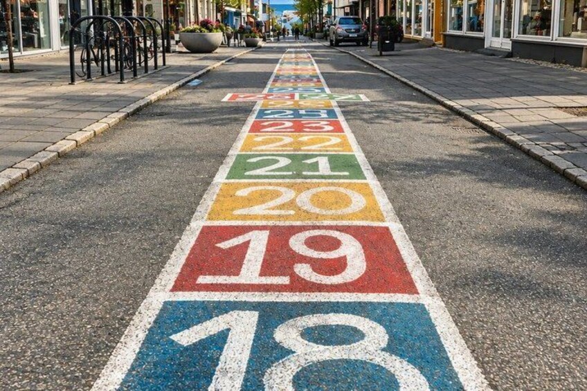 A road with colored lane markings indicating speed limits. 2